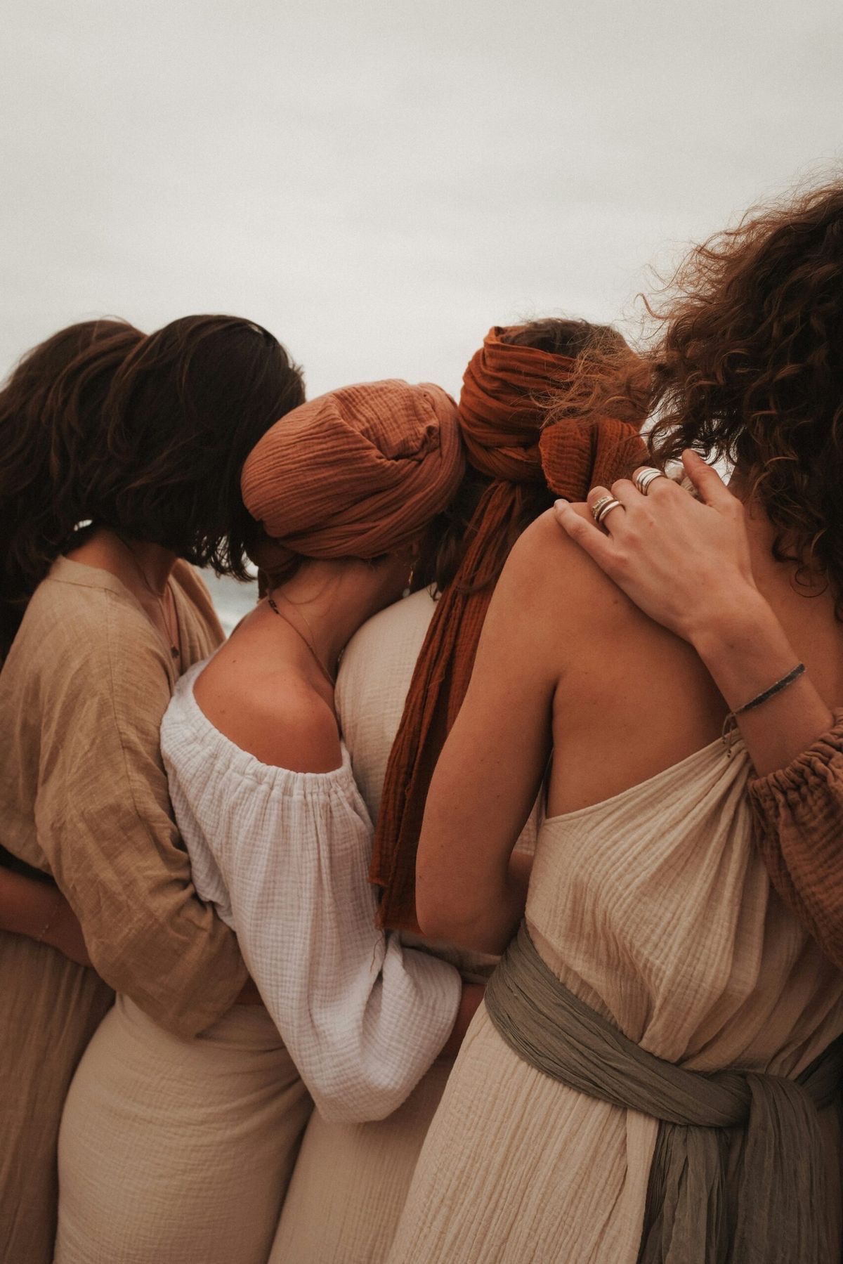 Women standing together with arms around each other